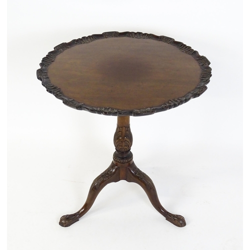 1618 - A mid 19thC mahogany tripod occasional table with a carved pie crust top and a birdcage movement. Th... 