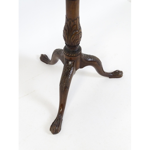 1618 - A mid 19thC mahogany tripod occasional table with a carved pie crust top and a birdcage movement. Th... 