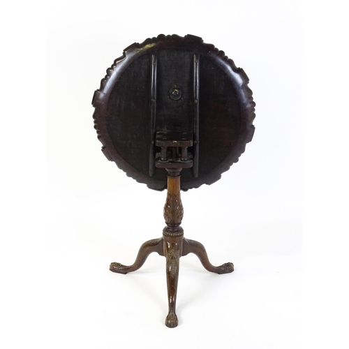 1618 - A mid 19thC mahogany tripod occasional table with a carved pie crust top and a birdcage movement. Th... 