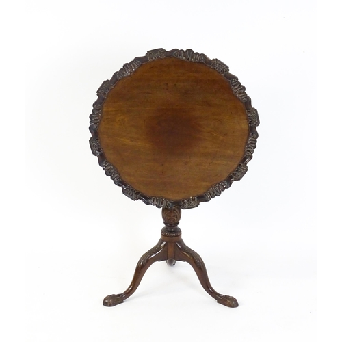 1618 - A mid 19thC mahogany tripod occasional table with a carved pie crust top and a birdcage movement. Th... 