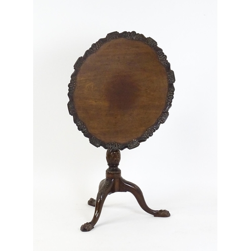 1618 - A mid 19thC mahogany tripod occasional table with a carved pie crust top and a birdcage movement. Th... 