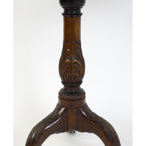 1618 - A mid 19thC mahogany tripod occasional table with a carved pie crust top and a birdcage movement. Th... 