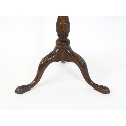 1618 - A mid 19thC mahogany tripod occasional table with a carved pie crust top and a birdcage movement. Th... 