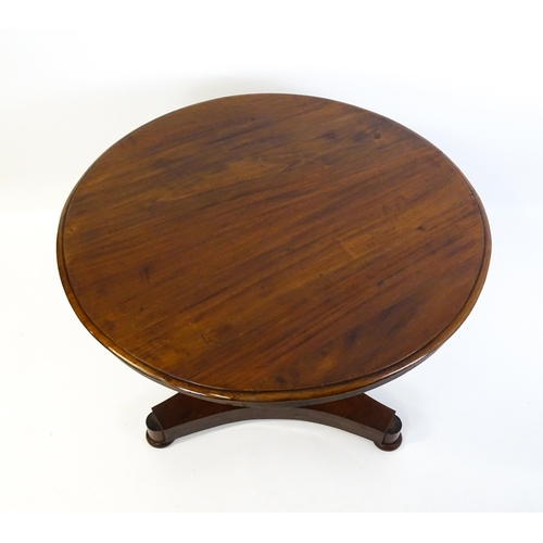 1621 - A Victorian mahogany pedestal table with a circular moulded top above a canted pedestal and triform ... 