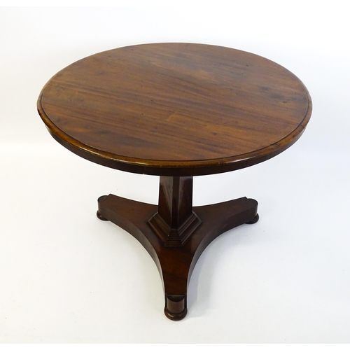 1621 - A Victorian mahogany pedestal table with a circular moulded top above a canted pedestal and triform ... 