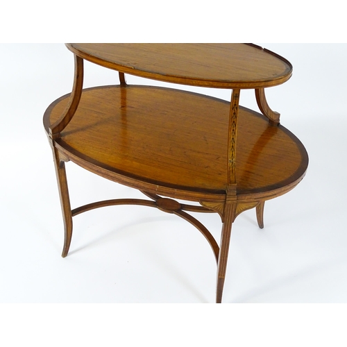 1623 - A late 19thC satinwood etagere with two oval crossbanded tiers raised on four splayed legs united by... 