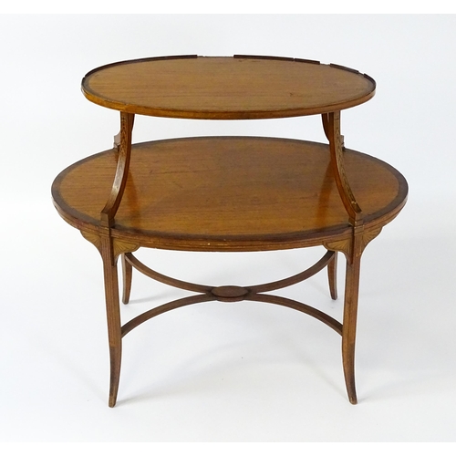 1623 - A late 19thC satinwood etagere with two oval crossbanded tiers raised on four splayed legs united by... 