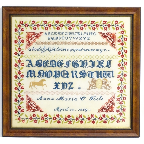 1984 - A needlework sampler embroidered with the letters of the alphabet, a horse and coat of arms, with a ... 