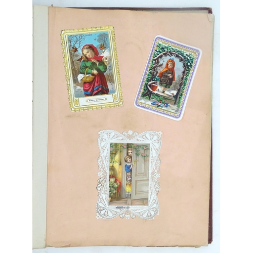 1970 - A Victorian scrapbook to include Christmas cards, greetings cards, scraps depicting cats, dogs, chil... 