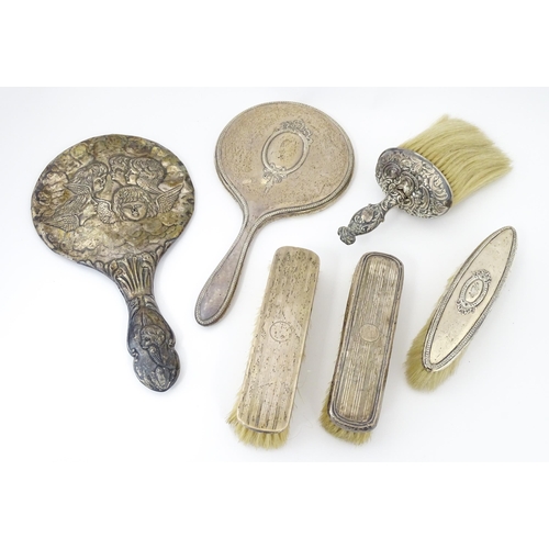 514 - A quantity of assorted silver dressing table items to include hand mirrors, brushes, etc. Various da... 