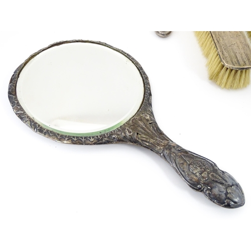 514 - A quantity of assorted silver dressing table items to include hand mirrors, brushes, etc. Various da... 