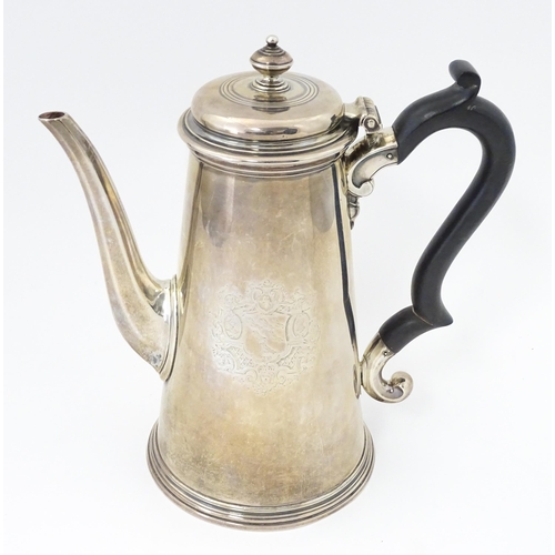 515 - A George II silver coffee pot with engraved armorial crests to sides, hallmarked London 1731, maker ... 