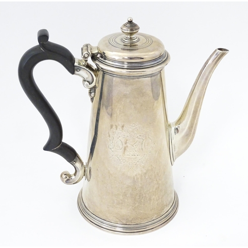 515 - A George II silver coffee pot with engraved armorial crests to sides, hallmarked London 1731, maker ... 