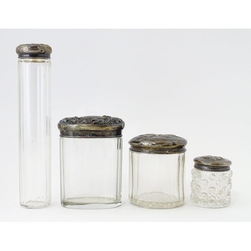 521 - A quantity of assorted glass dressing table bottles with silver lids, hallmarks to include Birmingha... 