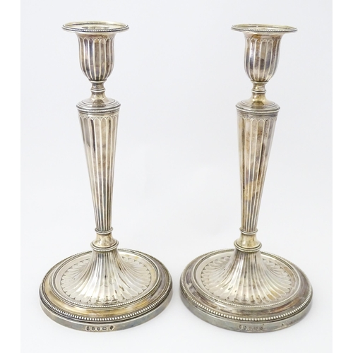 526 - A pair of George III Neo Classical silver candlesticks with engraved armorial detail, hallmarked Lon... 