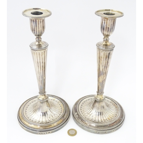 526 - A pair of George III Neo Classical silver candlesticks with engraved armorial detail, hallmarked Lon... 