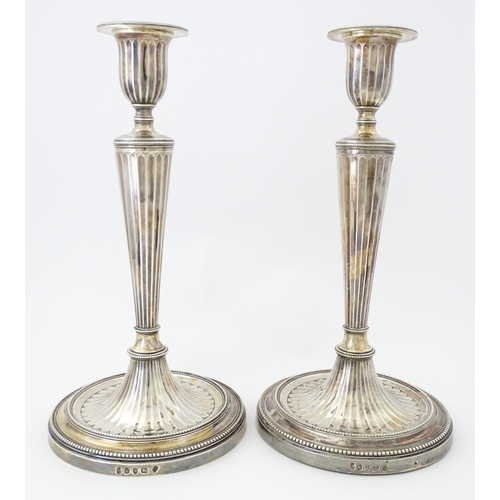 526 - A pair of George III Neo Classical silver candlesticks with engraved armorial detail, hallmarked Lon... 