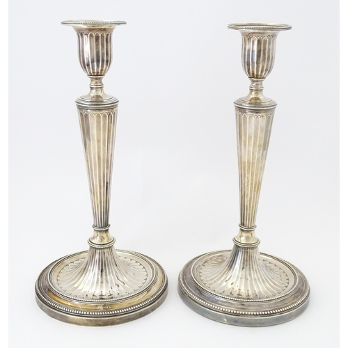 526 - A pair of George III Neo Classical silver candlesticks with engraved armorial detail, hallmarked Lon... 