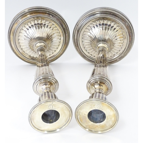 526 - A pair of George III Neo Classical silver candlesticks with engraved armorial detail, hallmarked Lon... 