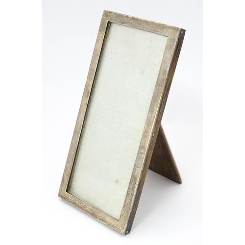 532 - An easel back photograph frame with silver surround hallmarked Birmingham 1920, maker Sanders & Mack... 