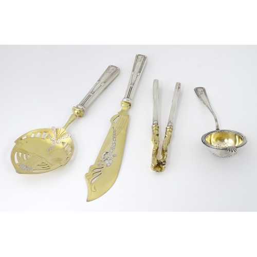 538 - A Chilean silver cased set comprising a strainer / sifter, server, nutcrackers, and knife, in the Ge... 