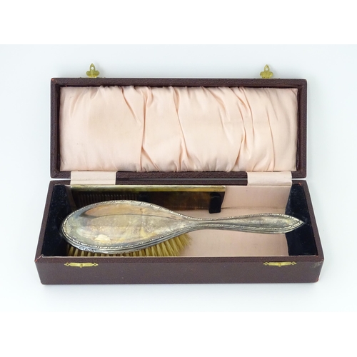 544 - A cased silver brush hallmarked Birmingham 1924, maker Daniel Manufacturing Company. Together with a... 