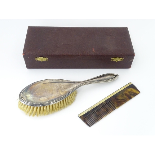 544 - A cased silver brush hallmarked Birmingham 1924, maker Daniel Manufacturing Company. Together with a... 