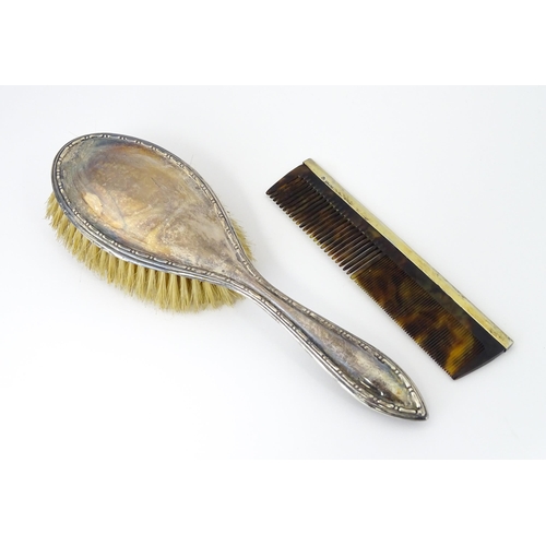 544 - A cased silver brush hallmarked Birmingham 1924, maker Daniel Manufacturing Company. Together with a... 