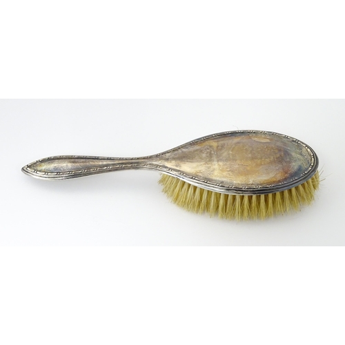 544 - A cased silver brush hallmarked Birmingham 1924, maker Daniel Manufacturing Company. Together with a... 