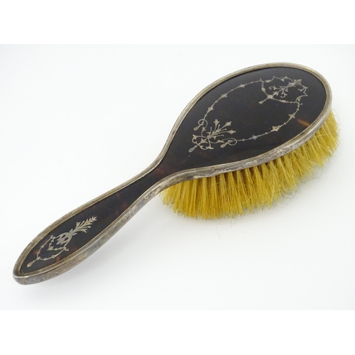 545 - Three individually cased silver dressing table items comprising two brushes and a hand mirror with t... 