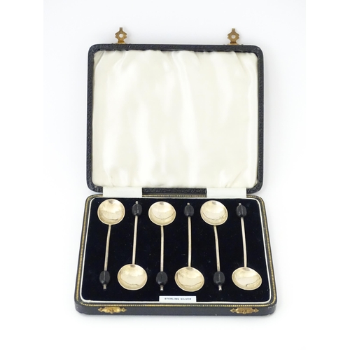 562 - A cased set of six silver coffee spoons with coffee bean finials, hallmarked Birmingham 1934, maker ... 