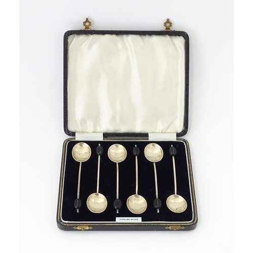 562 - A cased set of six silver coffee spoons with coffee bean finials, hallmarked Birmingham 1934, maker ... 