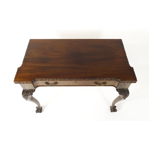 1449 - An Irish Chippendale mahogany card table with a carved inverted breakfront top, opening to show a ba... 