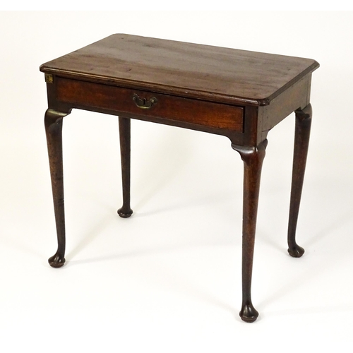 1472 - A George III mahogany side table with re-entrant corners above a single frieze drawer raised on four... 