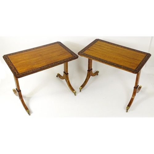 1482 - A pair of early 20thC satinwood library tables with an ebonised surround and floral marquetry decora... 