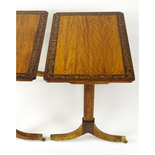 1482 - A pair of early 20thC satinwood library tables with an ebonised surround and floral marquetry decora... 