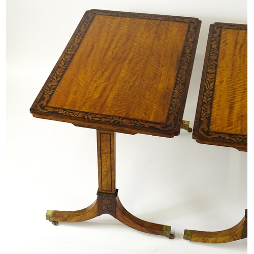 1482 - A pair of early 20thC satinwood library tables with an ebonised surround and floral marquetry decora... 