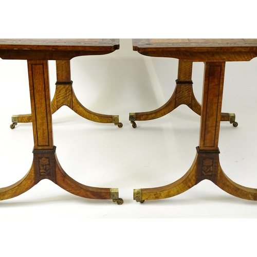 1482 - A pair of early 20thC satinwood library tables with an ebonised surround and floral marquetry decora... 