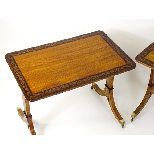 1482 - A pair of early 20thC satinwood library tables with an ebonised surround and floral marquetry decora... 