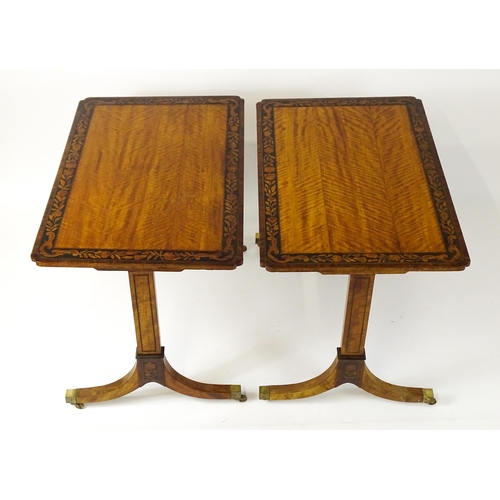 1482 - A pair of early 20thC satinwood library tables with an ebonised surround and floral marquetry decora... 