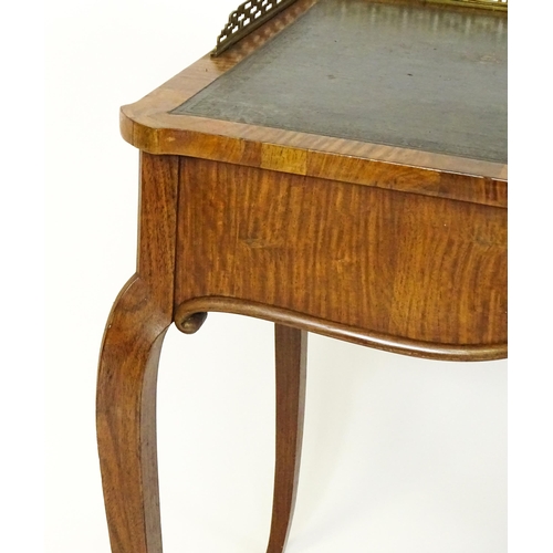 1496 - A 19thC satinwood writing desk surmounted by a bras pierced gallery above a single short drawer with... 