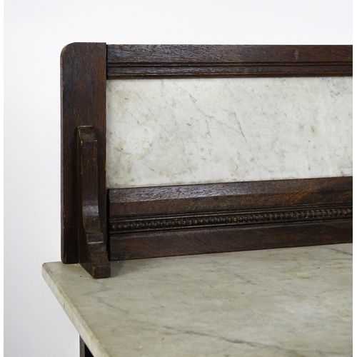 1501 - An early 20thC marble topped washstand with a raised splashback above single panelled door raised on... 