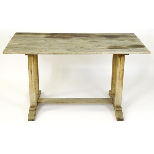 1506 - An early 20thC Heals style oak trestle table with a planked top. 54