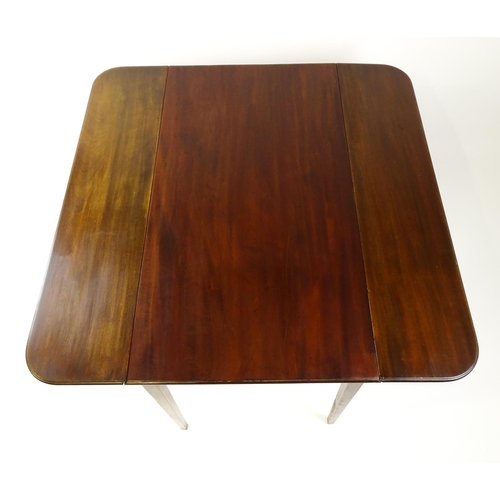 1523 - A 19thC mahogany drop flap table raised on four straight tapering legs. 23