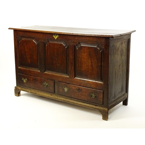 1526 - A George II mule chest with a hinged lid above a triple panelled front and two short drawers raised ... 