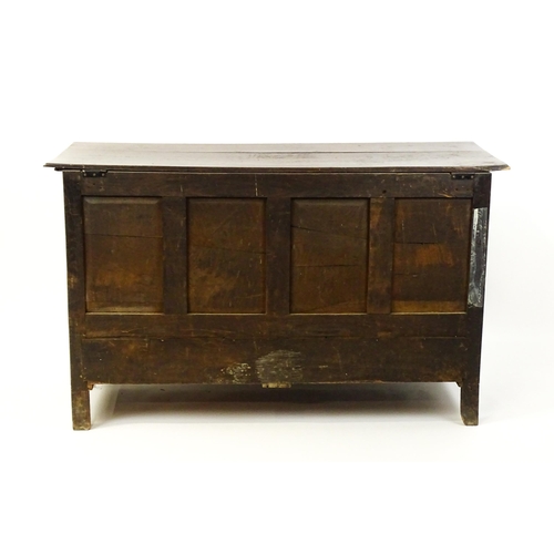 1526 - A George II mule chest with a hinged lid above a triple panelled front and two short drawers raised ... 