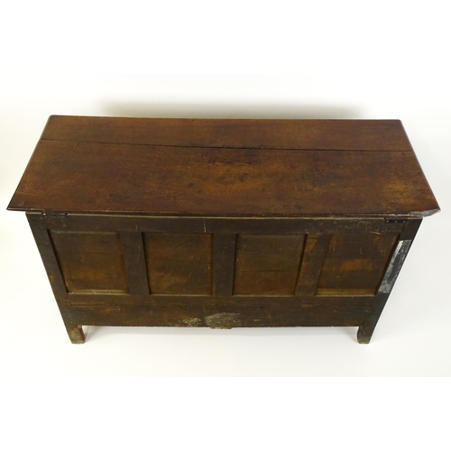 1526 - A George II mule chest with a hinged lid above a triple panelled front and two short drawers raised ... 