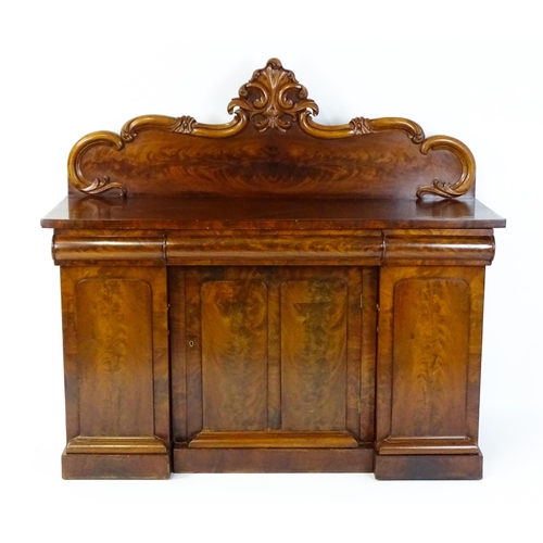 1528 - A 19thC mahogany sideboard with a carved, shaped upstand above three short drawers, the  pedestal ba... 