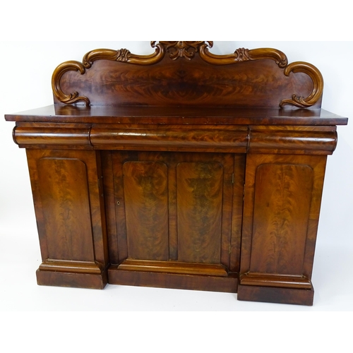 1528 - A 19thC mahogany sideboard with a carved, shaped upstand above three short drawers, the  pedestal ba... 