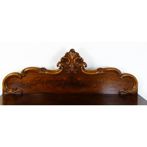 1528 - A 19thC mahogany sideboard with a carved, shaped upstand above three short drawers, the  pedestal ba... 